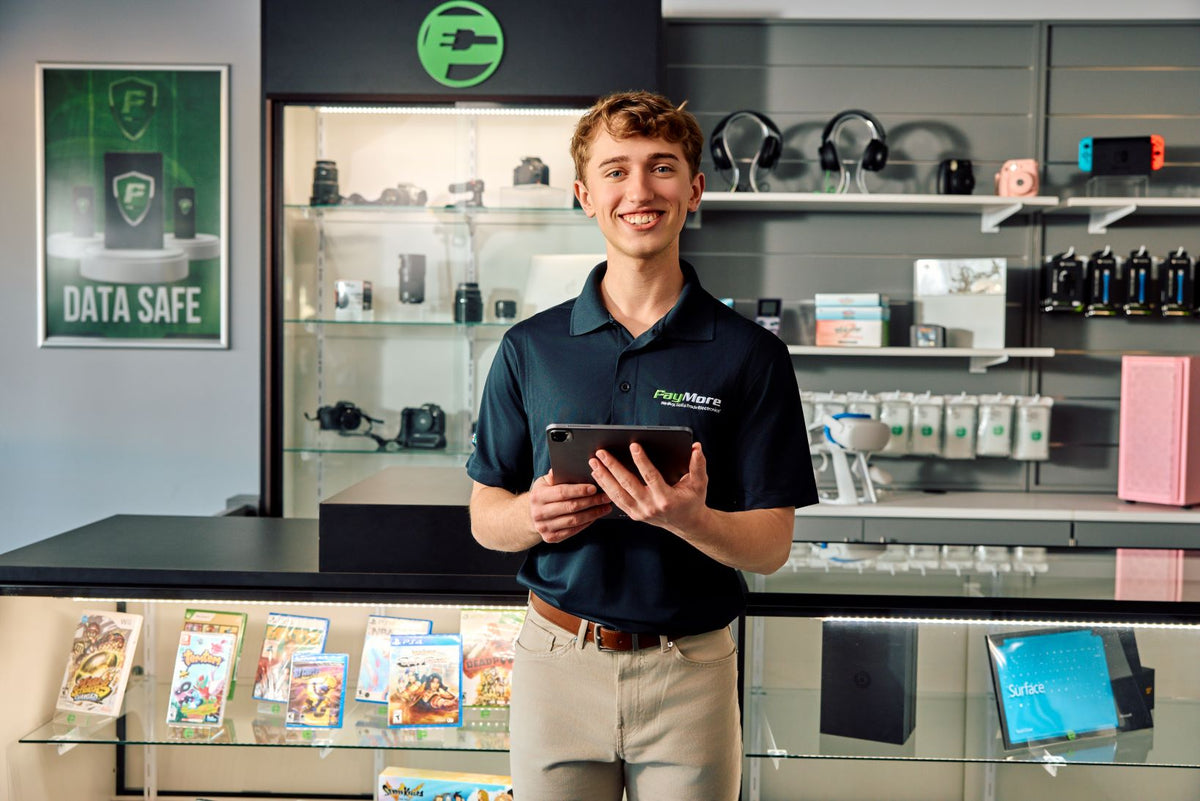 employee smiling and holding a tablet